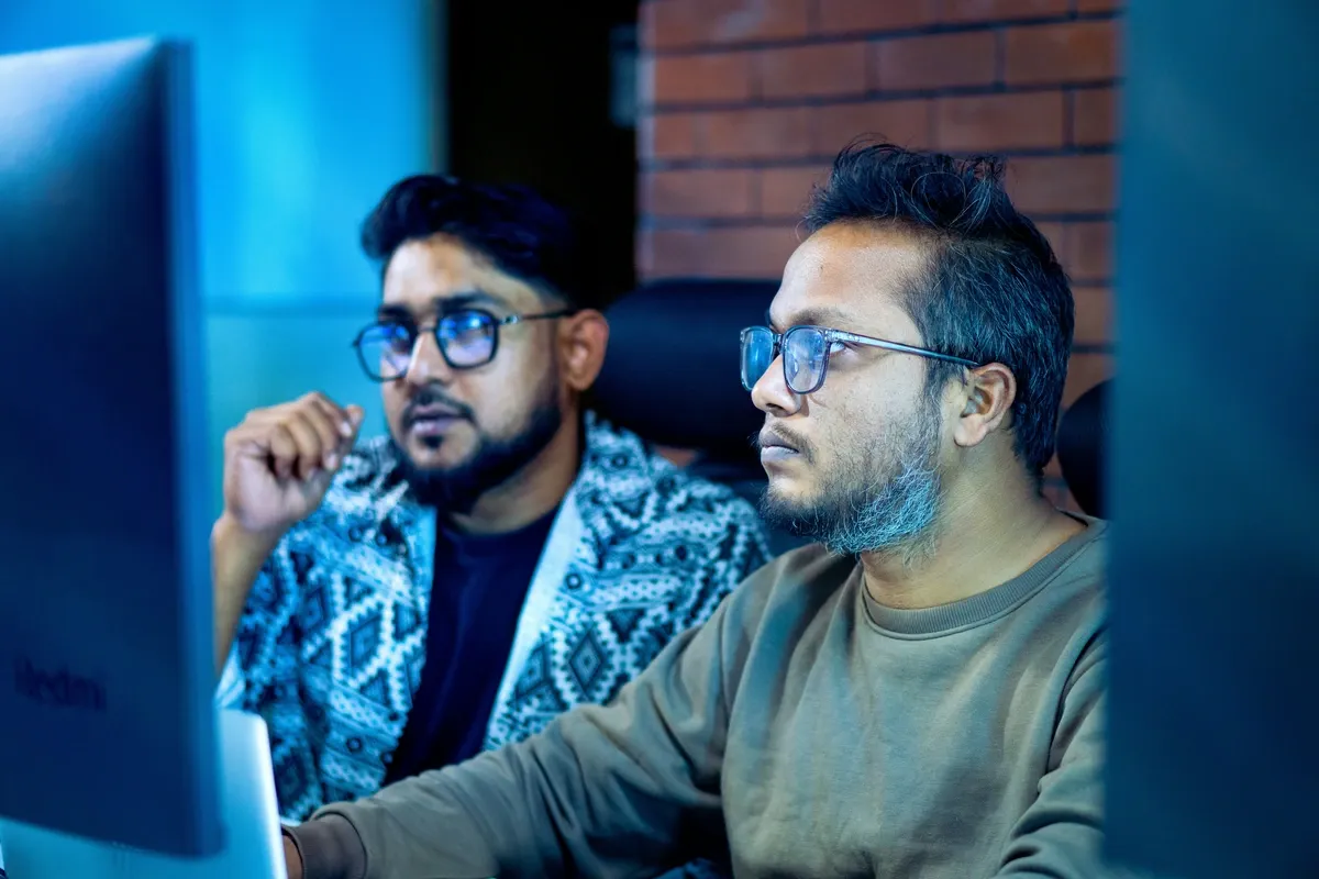 Two colleagues troubleshooting at a computer